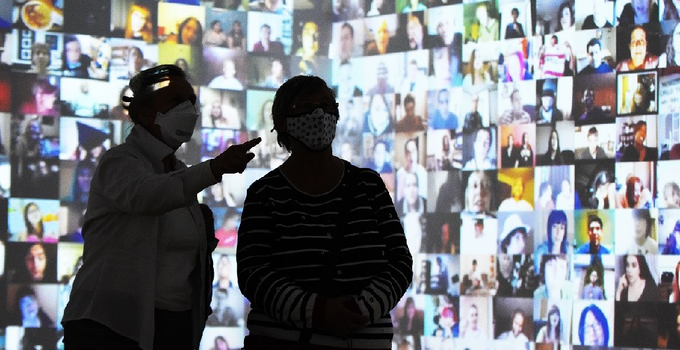 Two women looking at contemporary art exhibition in The Box 